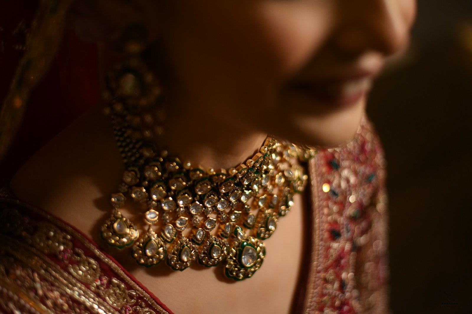 Close-up of elaborate bridal jewellery necklace on Indian bride, detail shot by wedding production house India