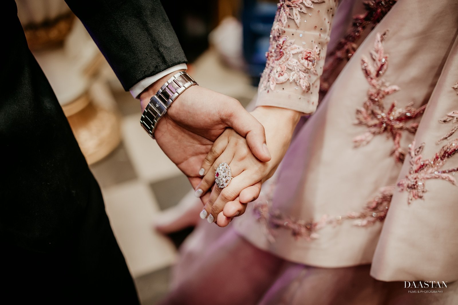Close-up of intricate embroidery on bridal lehenga, detail shot from Indian wedding reception