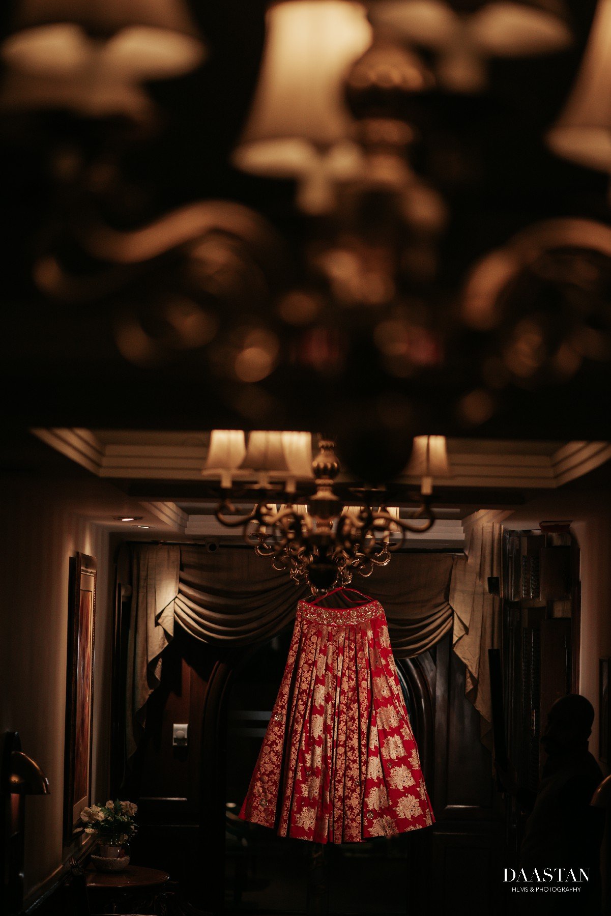 Artistic display of red bridal lehenga, detail shot by professional Indian wedding production house