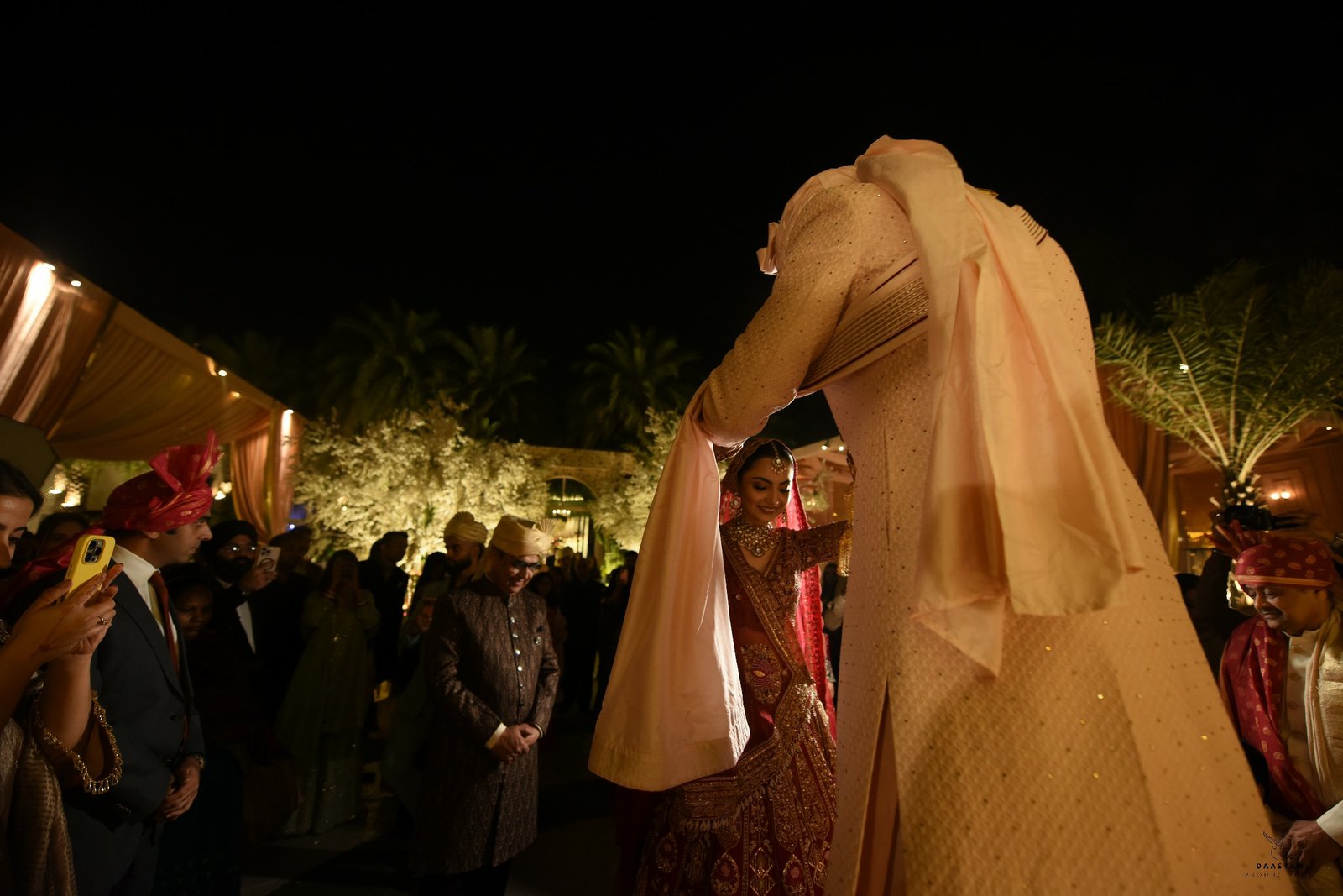 Artistic portrait of Indian bride with dupatta draped over face, editorial wedding photography