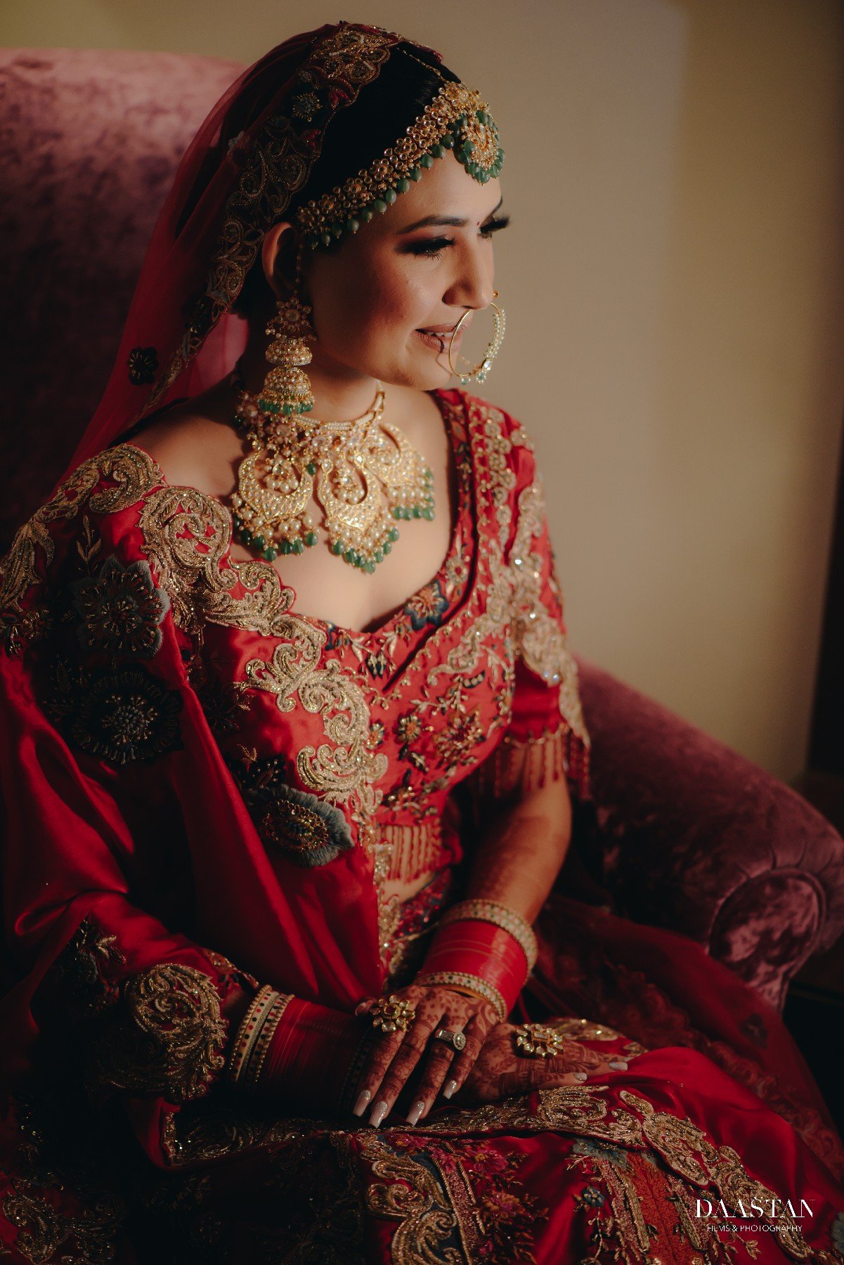 Studio-quality bridal portrait of Indian bride in red lehenga, professional wedding production house