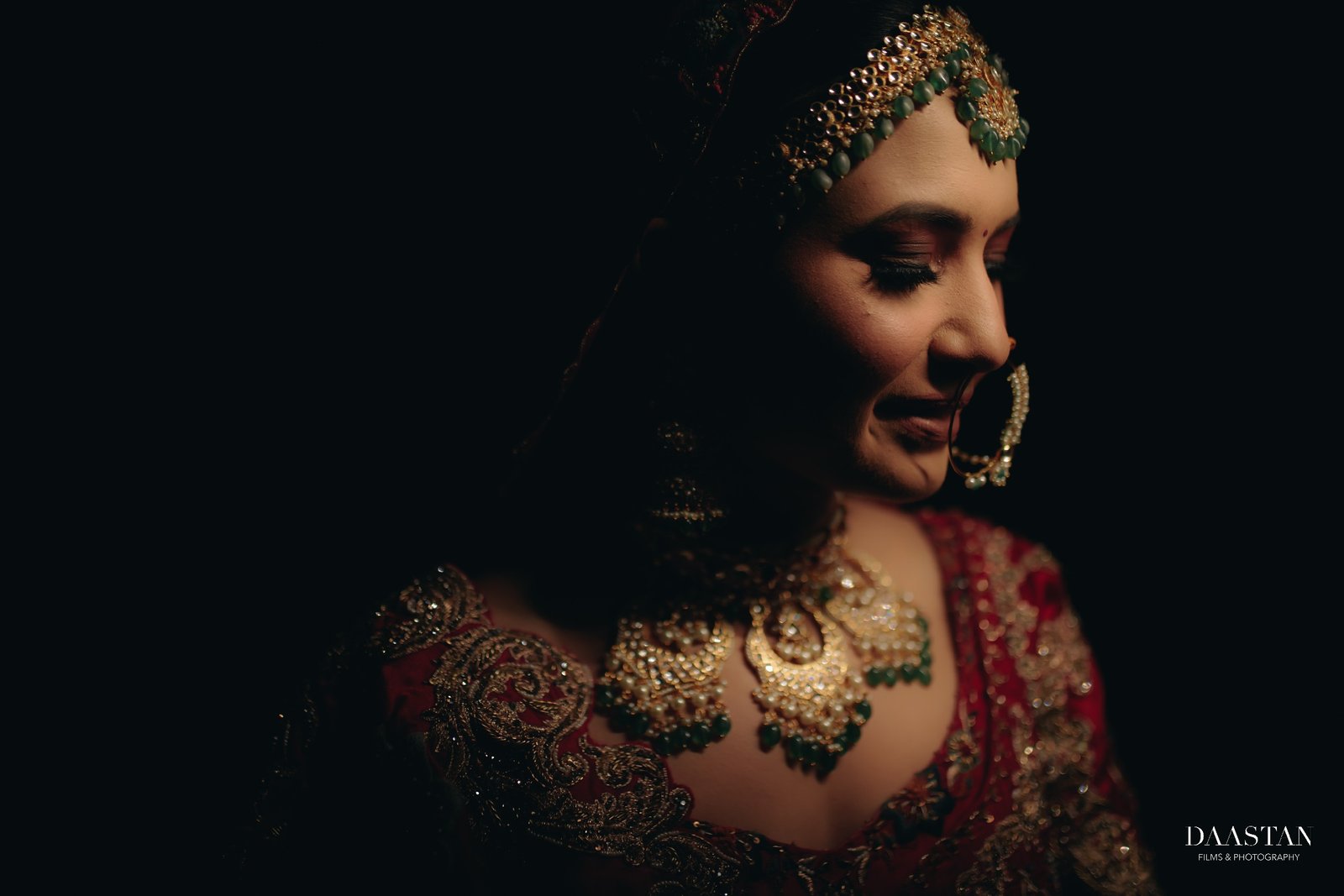 Dark moody bridal portrait of Indian bride with dramatic lighting, cinematic wedding photography