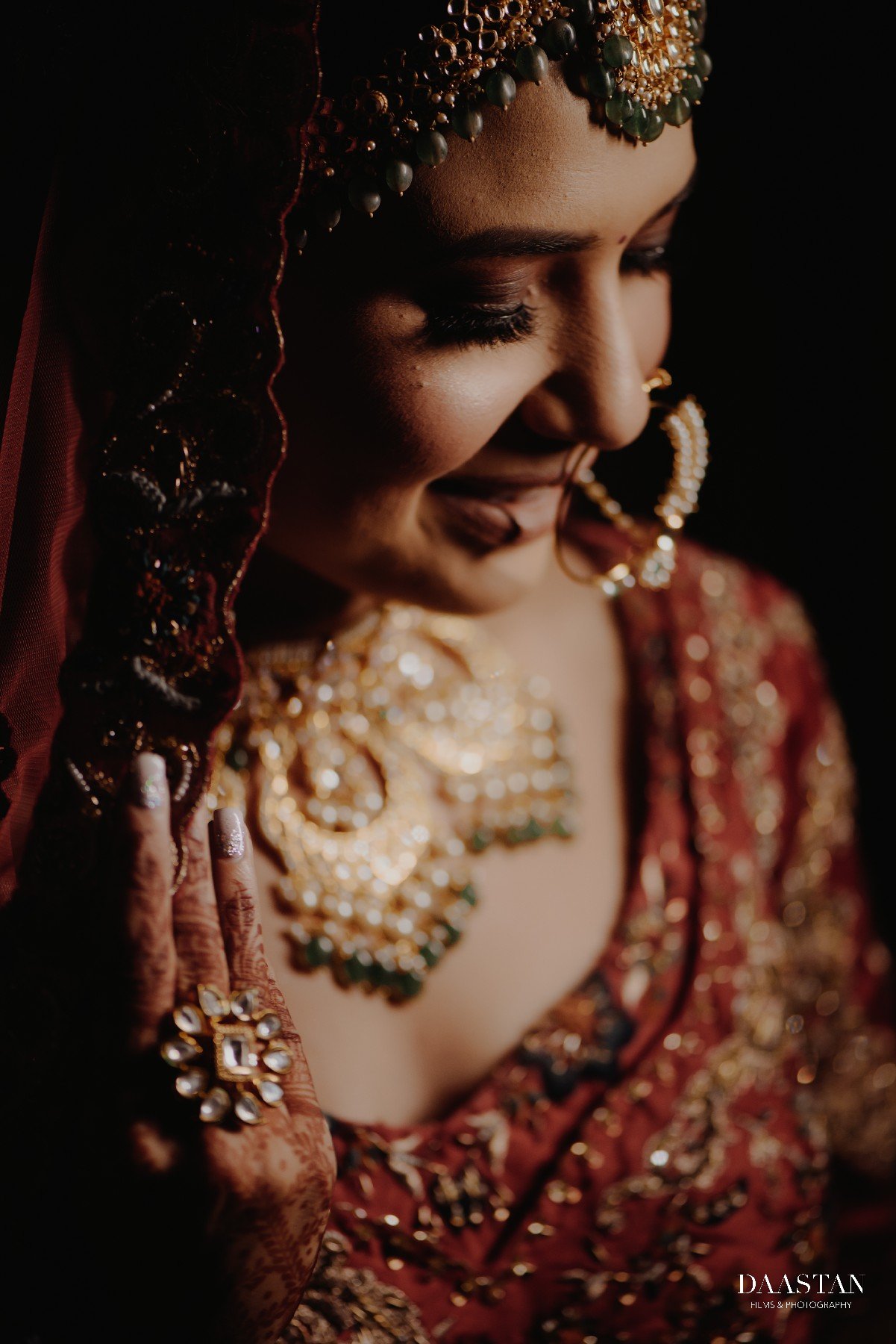 Moody and dramatic bridal portrait with rich jewellery, dark background Indian wedding photography