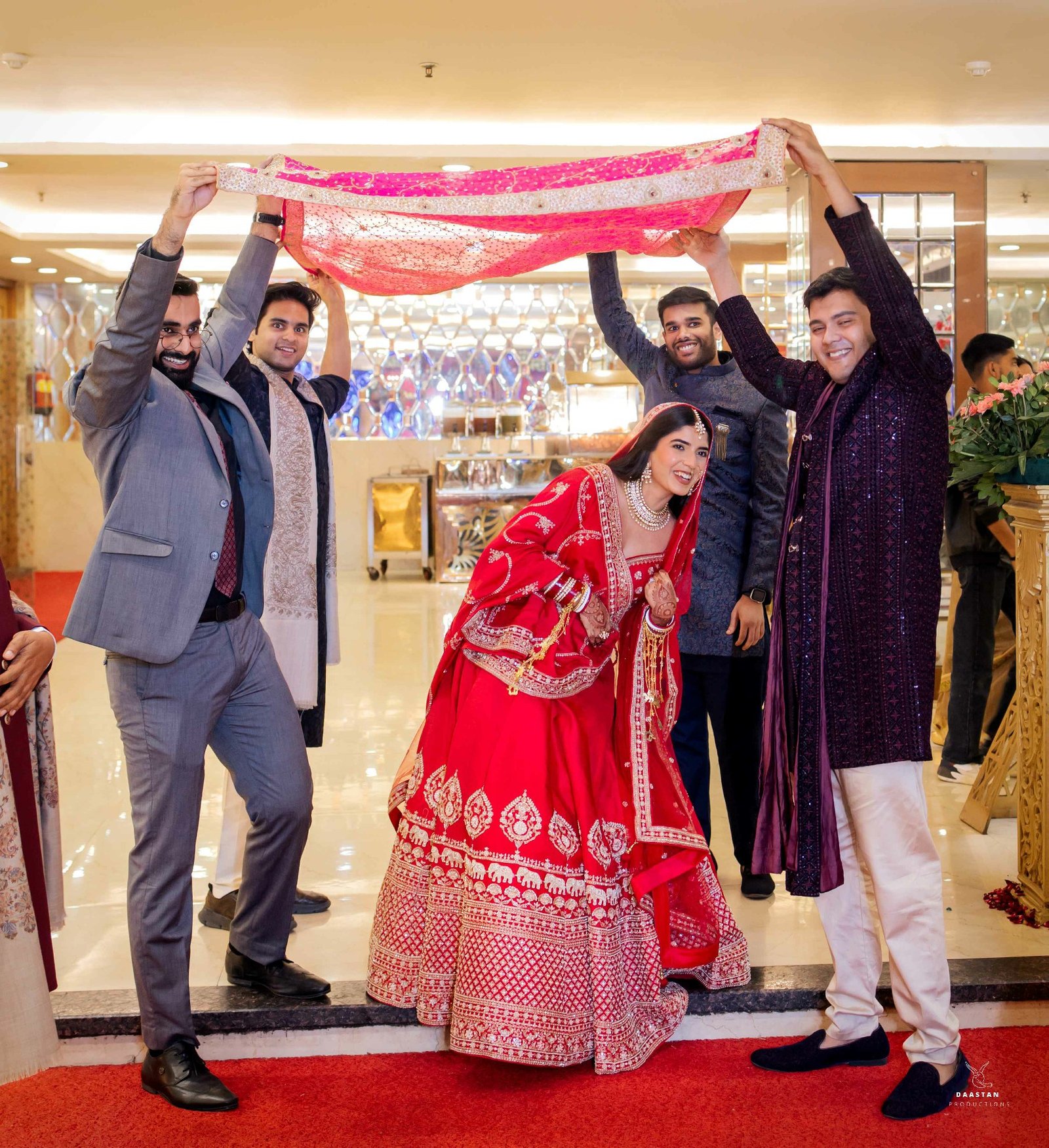 Traditional bride entry under phoolon ki chaadar with family, cinematic Indian wedding photography