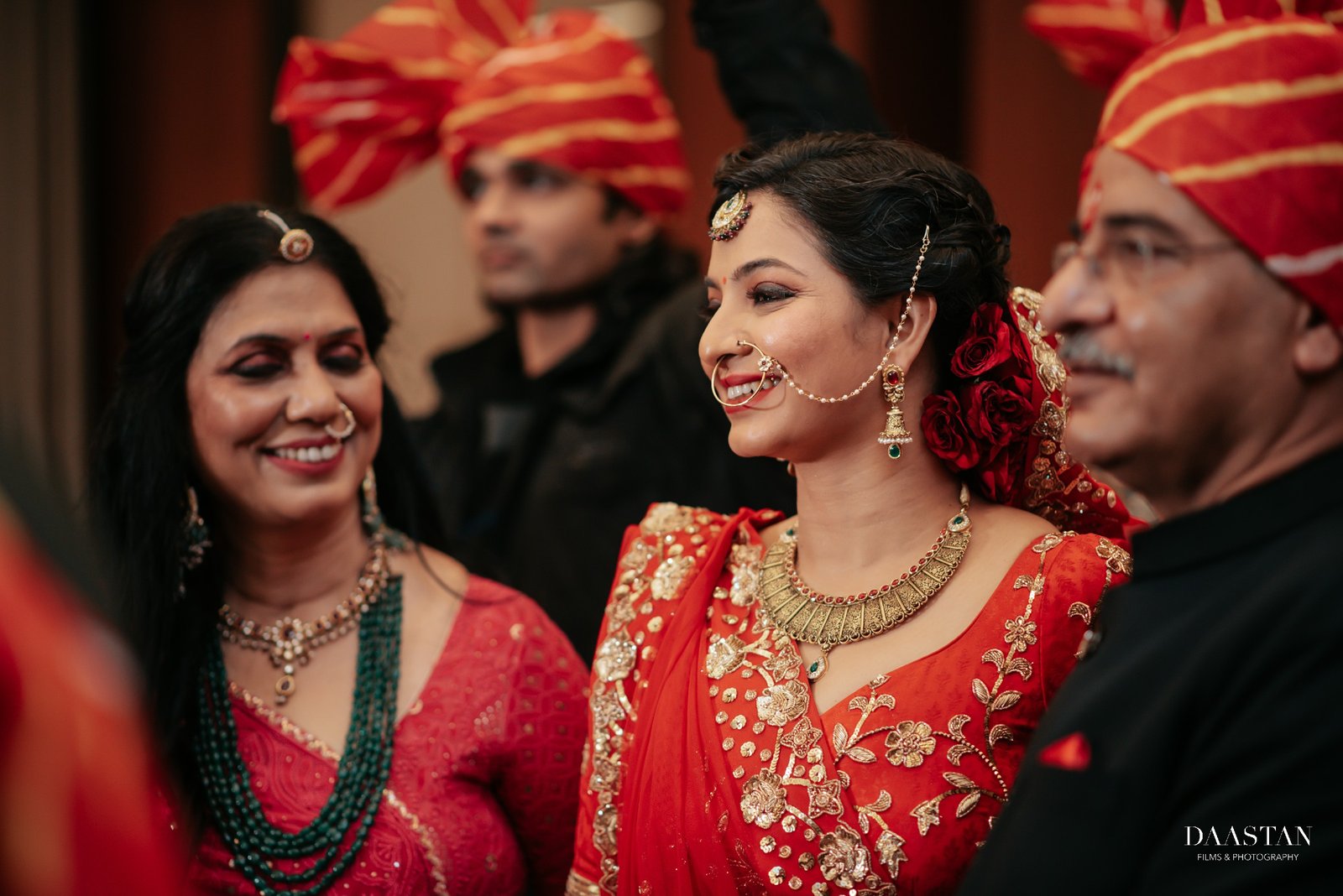 Bride with family during candid reception moment, Indian wedding production house photography