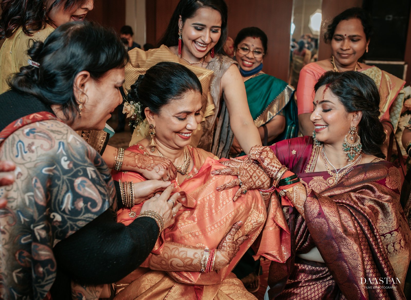 Bride getting ready with family members, candid behind-the-scenes wedding photography India