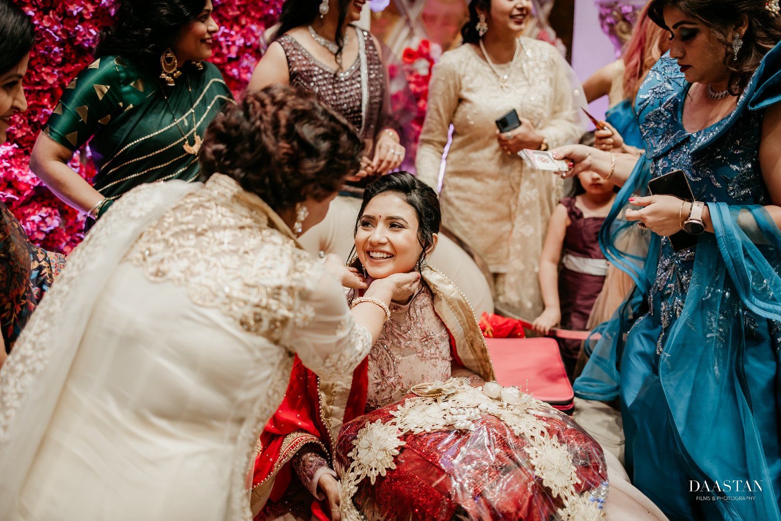 Candid fun moment between bride and family members at reception, Indian wedding photography