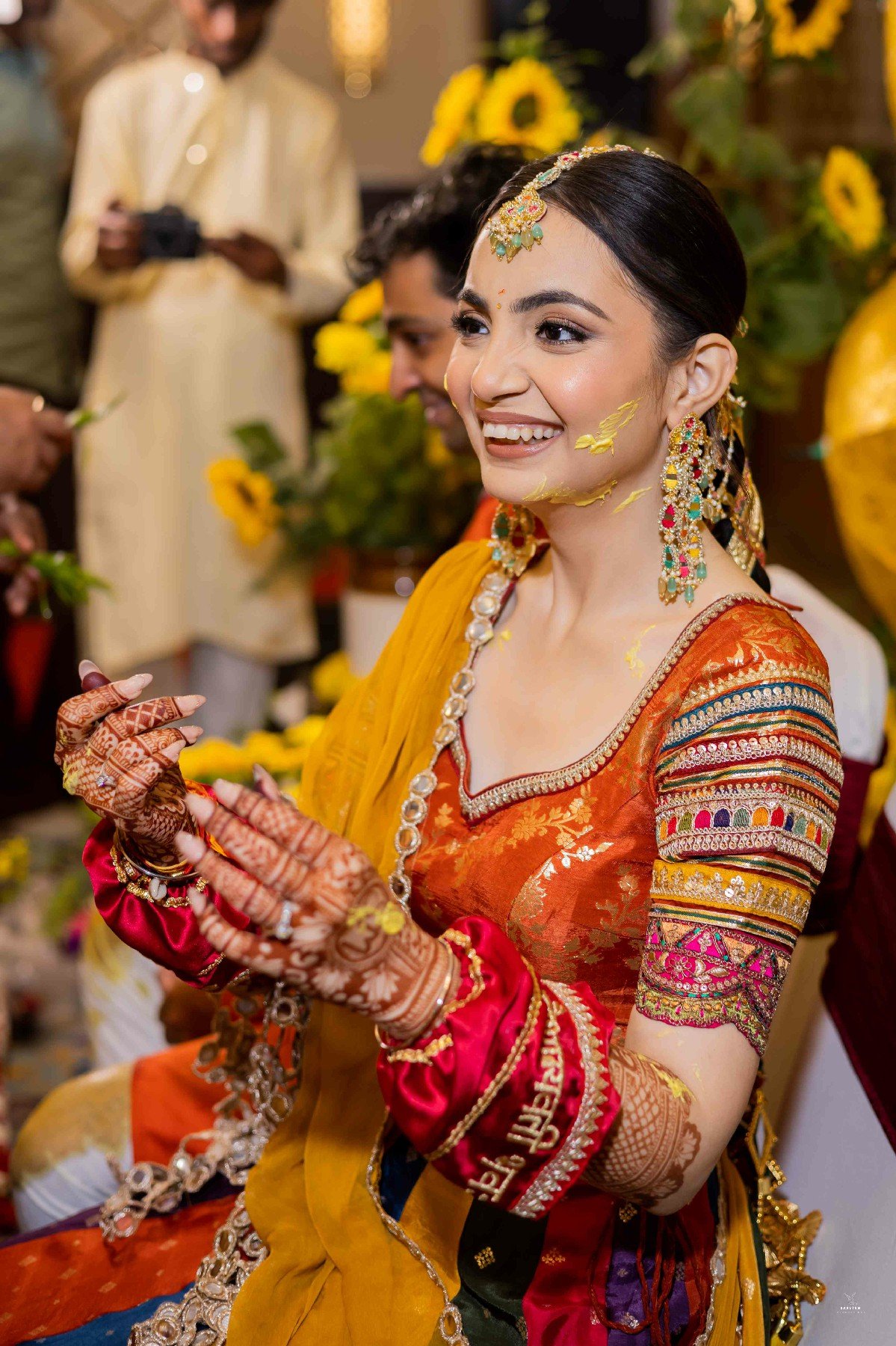 Smiling bride in marigold haldi decor, beautiful pre-wedding haldi portrait by Indian production house
