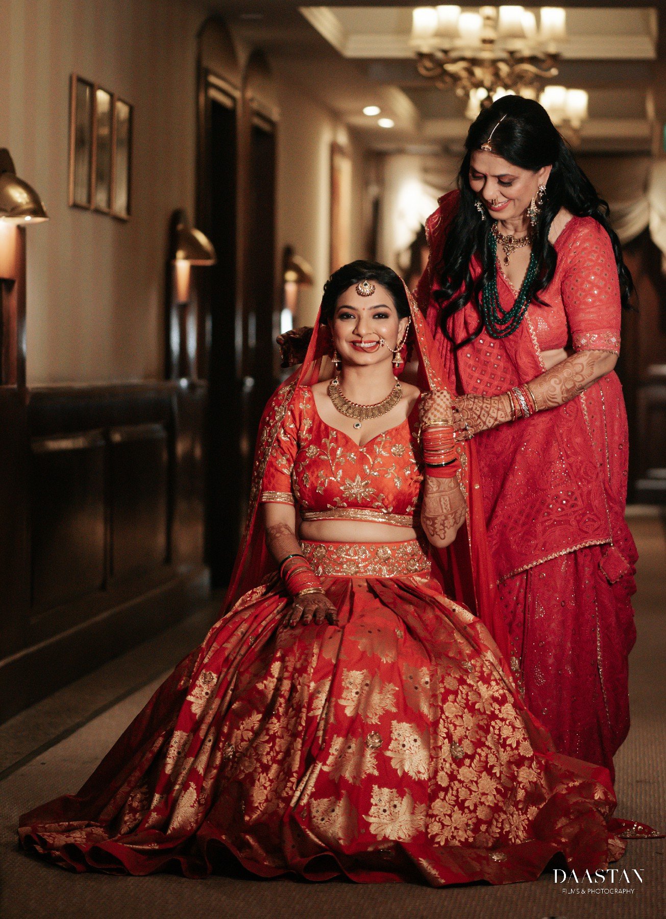 Bride in pink lehenga photographed in hotel corridor, elegant wedding portrait photography India