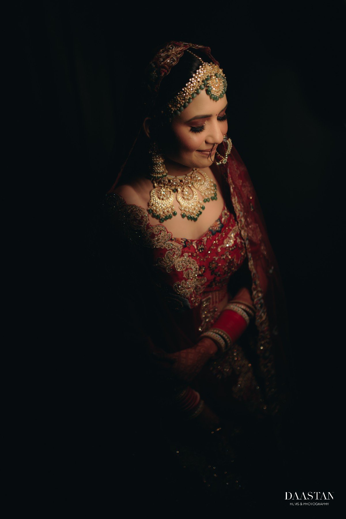 Moody low-light bridal portrait with bokeh background, cinematic Indian wedding photography