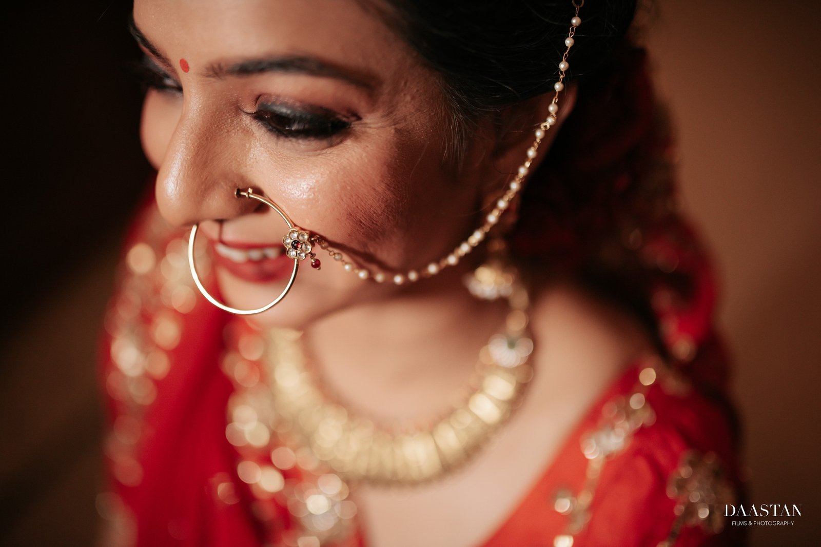 Close-up portrait of Indian bride with pearl nosepin and bridal jewellery, cinematic wedding photography