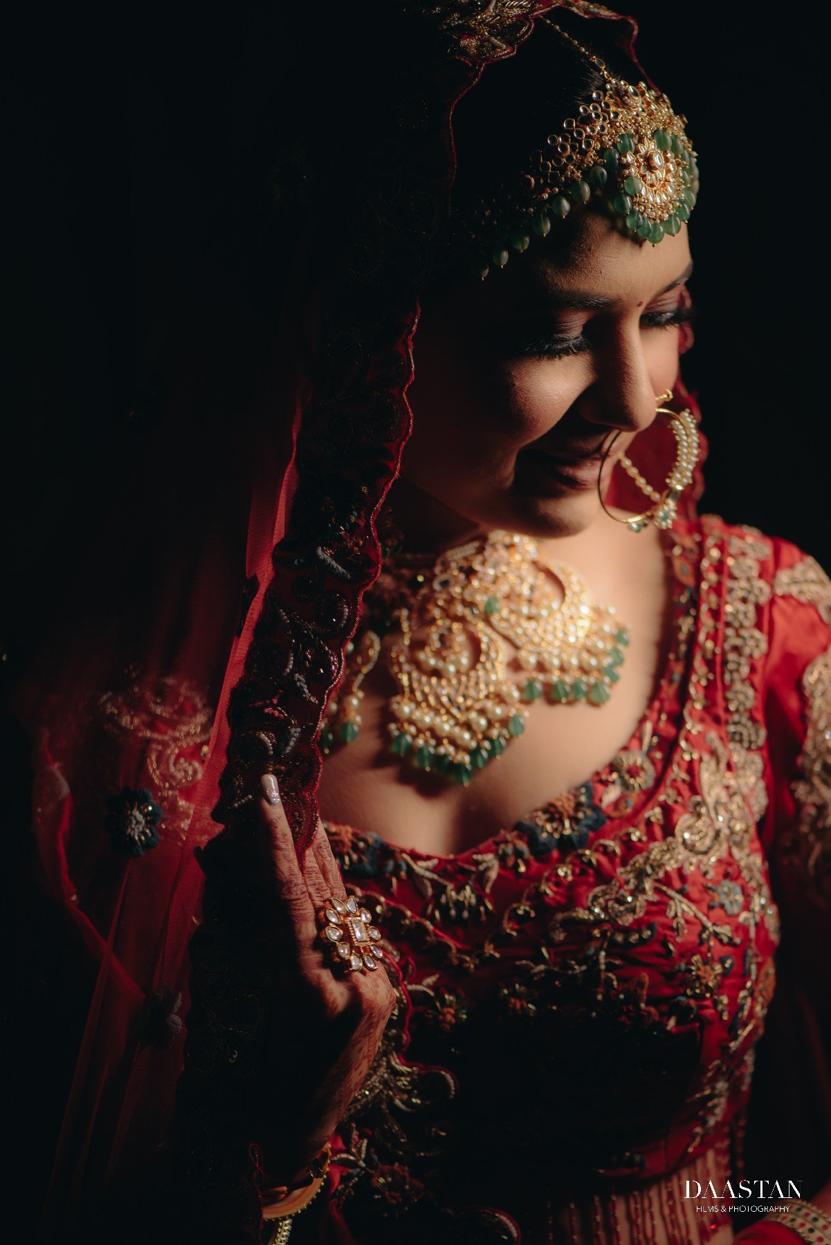 Stunning close-up of Indian bride in red lehenga with maang tikka and polki jewellery