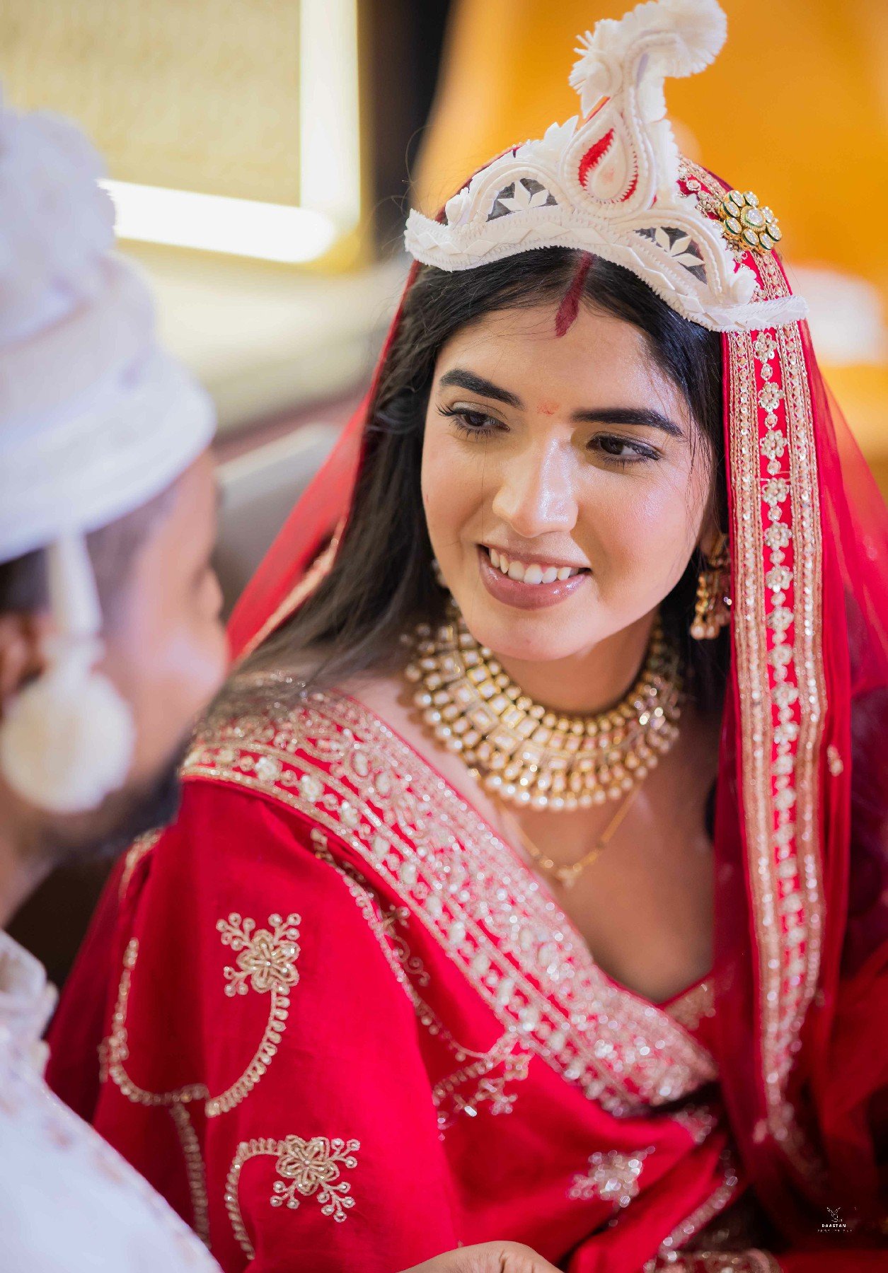Bride in red bridal lehenga with traditional topknot hairstyle, portrait wedding photography India
