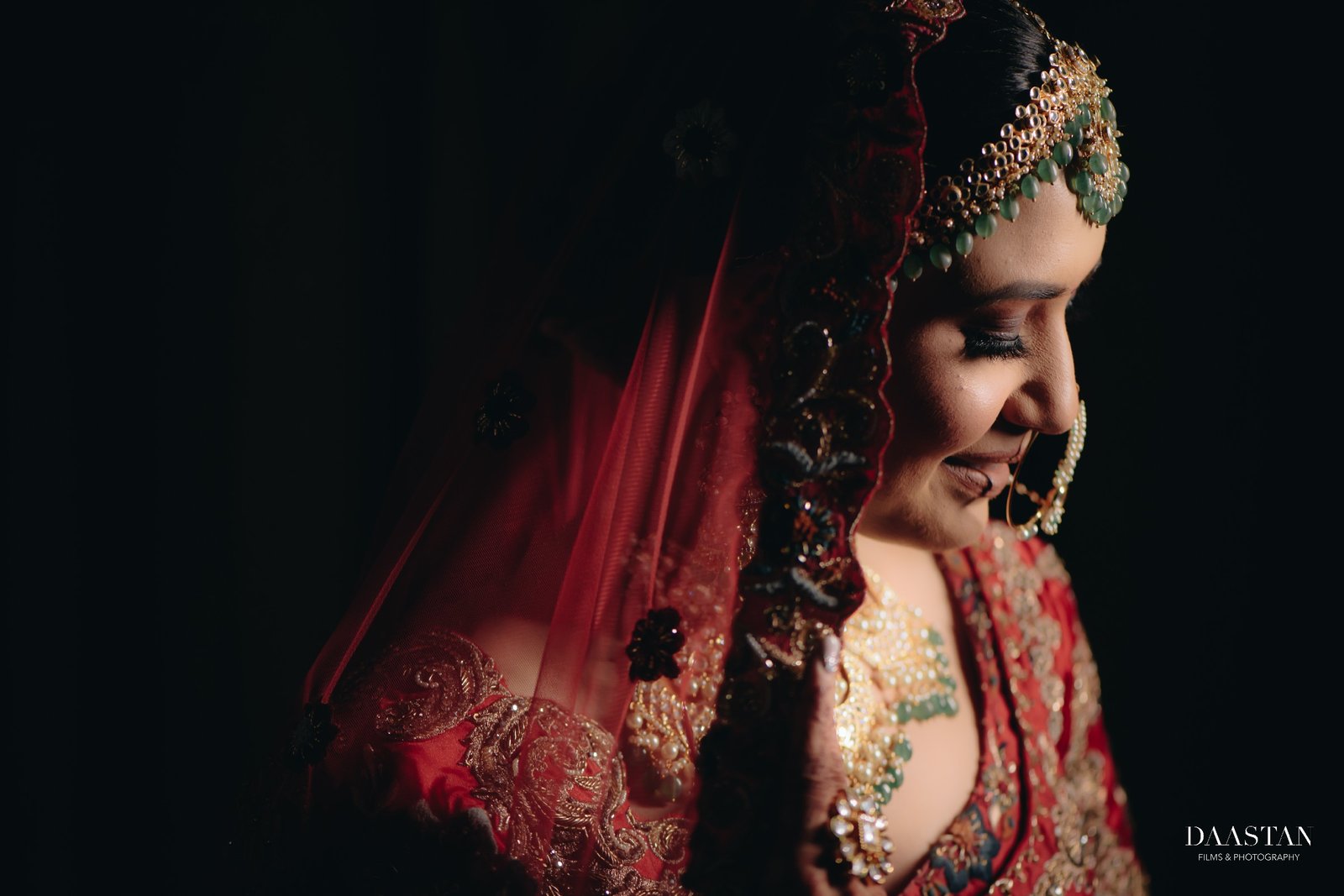 Artistic side-profile bridal portrait in moody low light, cinematic wedding photography India