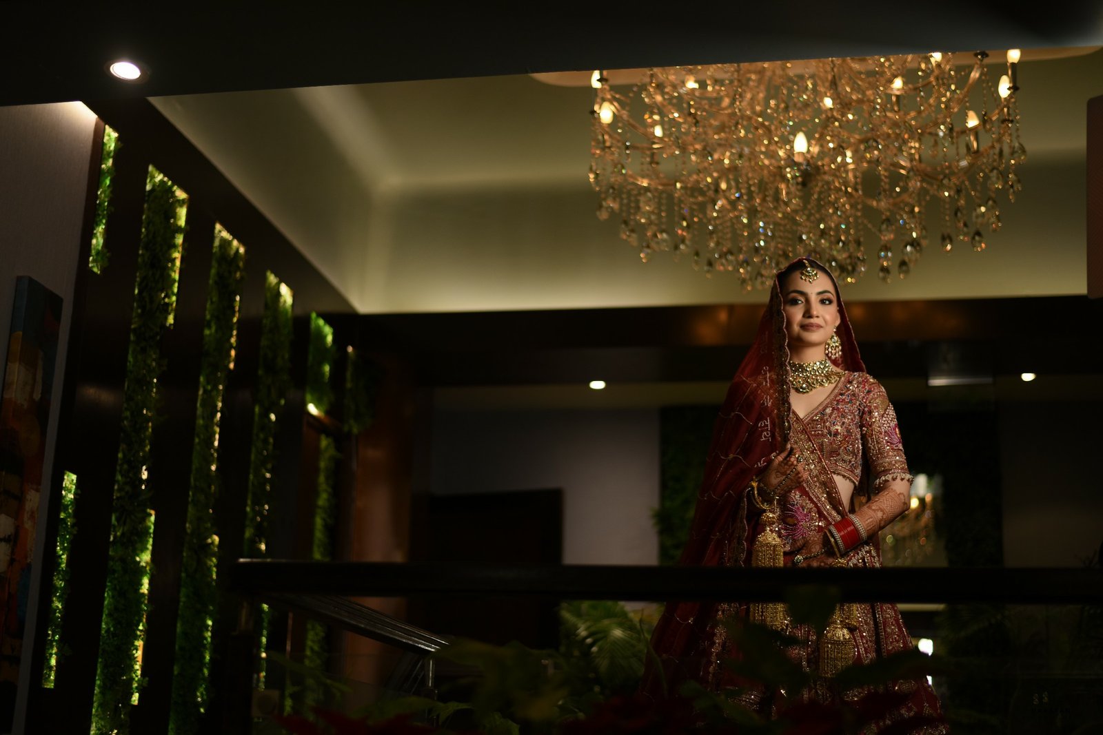 Bride descending grand hotel staircase, cinematic wedding portrait by professional Indian production house