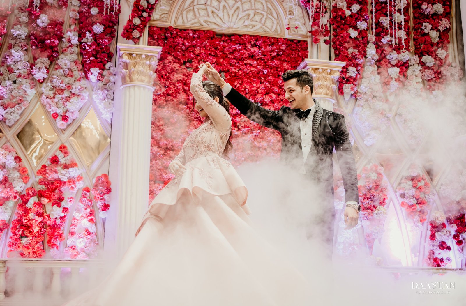 Couple sharing first dance on stage at Indian wedding reception, professional wedding production house