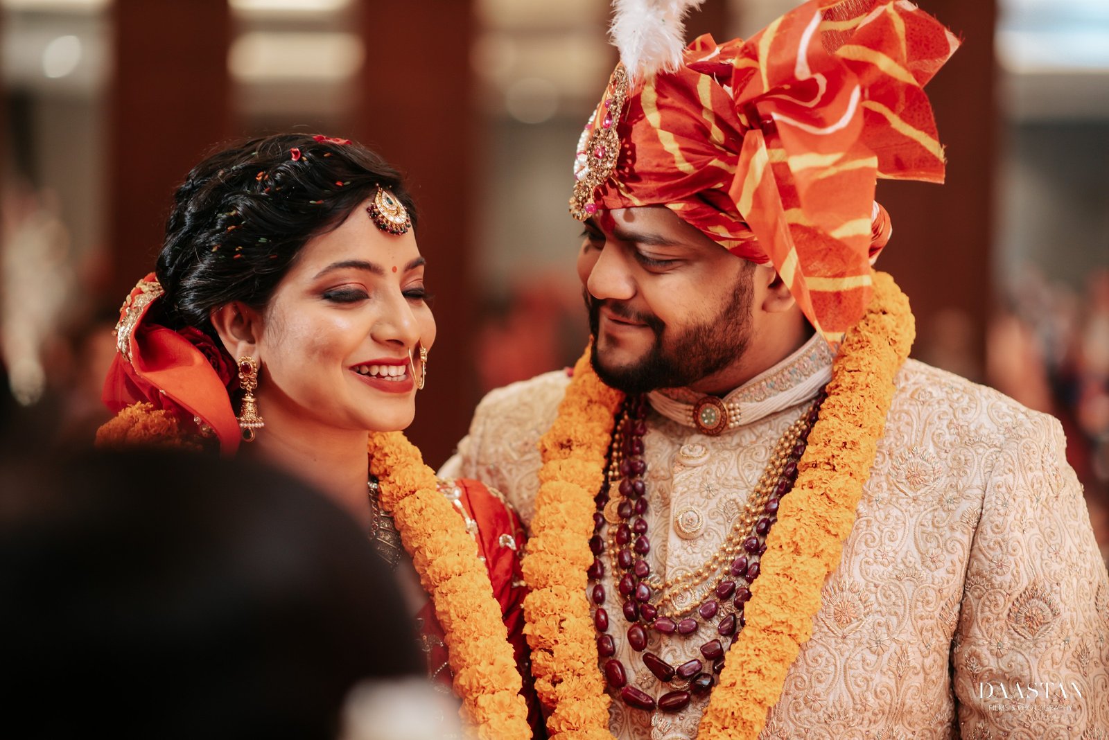 Couple smiling at each other during pheras ceremony, joyful Indian wedding photography