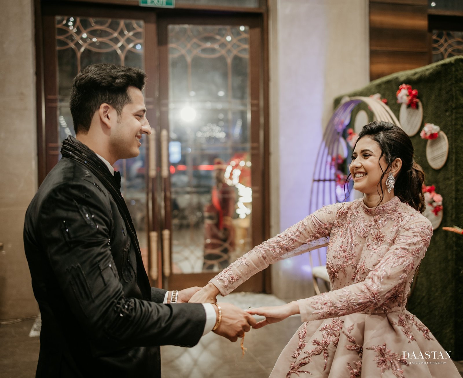 Couple sharing first dance at wedding reception, candid professional photography by Indian production house
