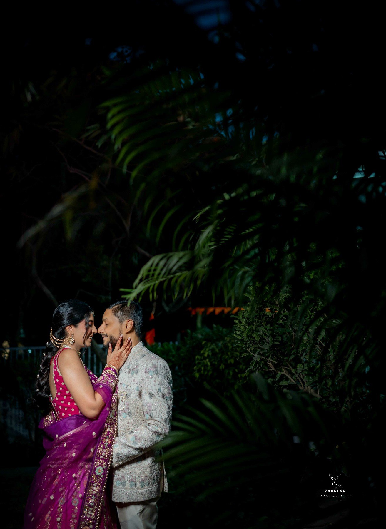 Romantic couple portrait in botanical garden setting, cinematic wedding photography by Indian production house