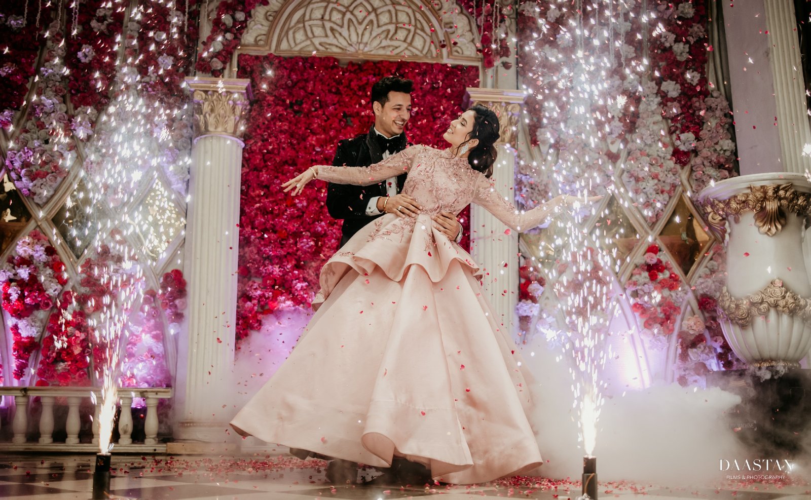 Bride and groom sparkler grand entry at wedding reception, cinematic Indian wedding photography