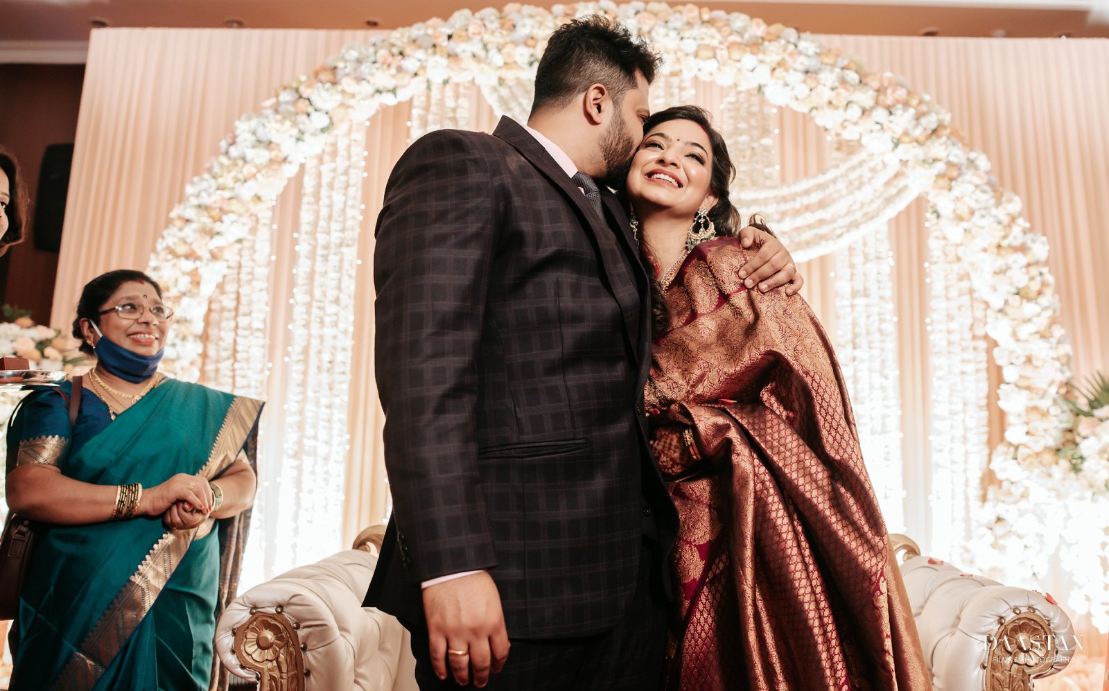 Couple sharing a candid joyful moment on wedding stage, luxury Indian wedding production photography