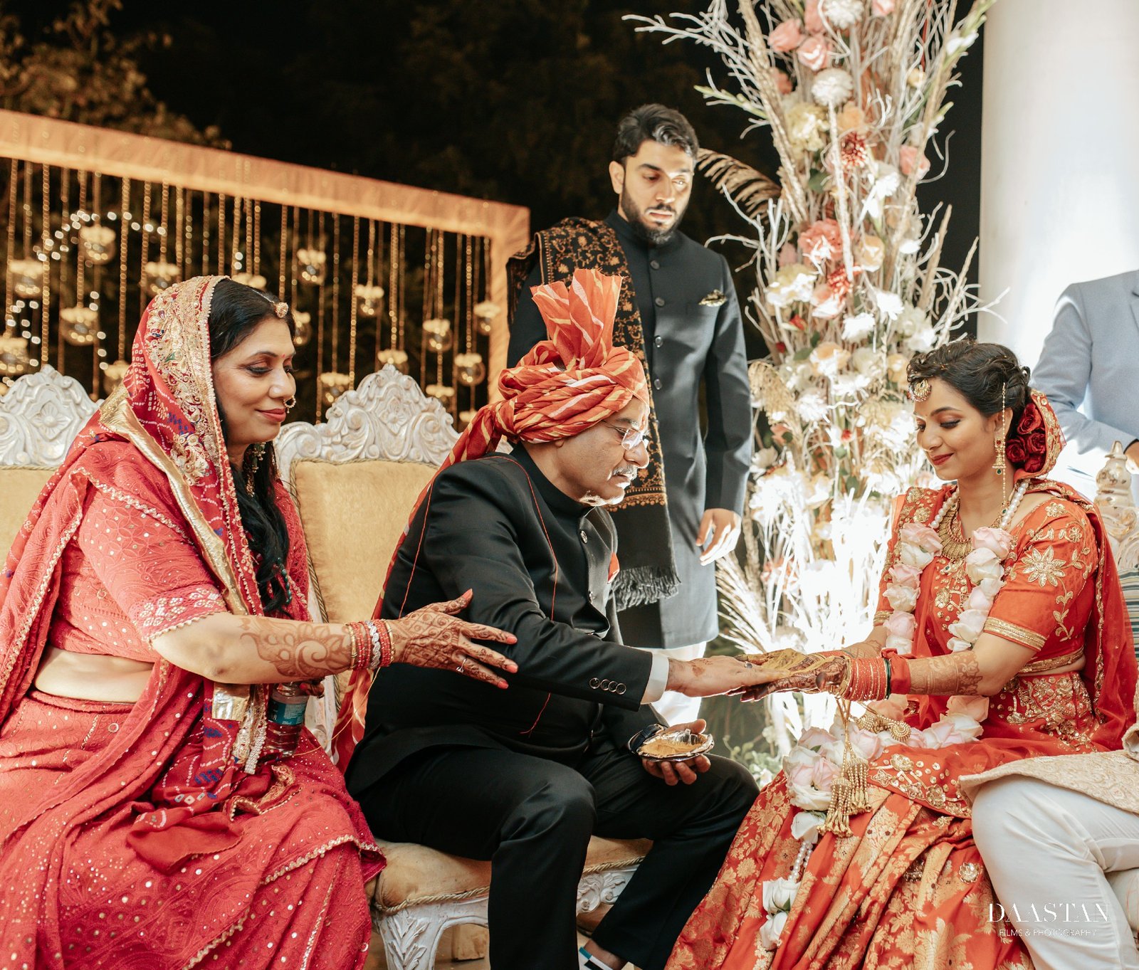Couple at wedding stage under phoolon ki chaadar decoration, luxury Indian wedding photography