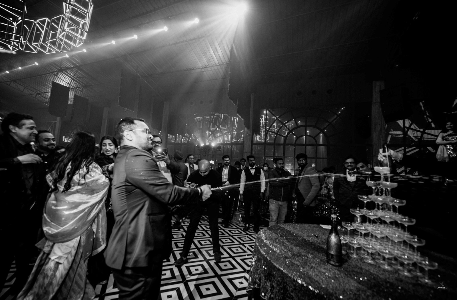 Moody ambiance shot of guests dancing at DJ night wedding reception, Indian wedding production photography