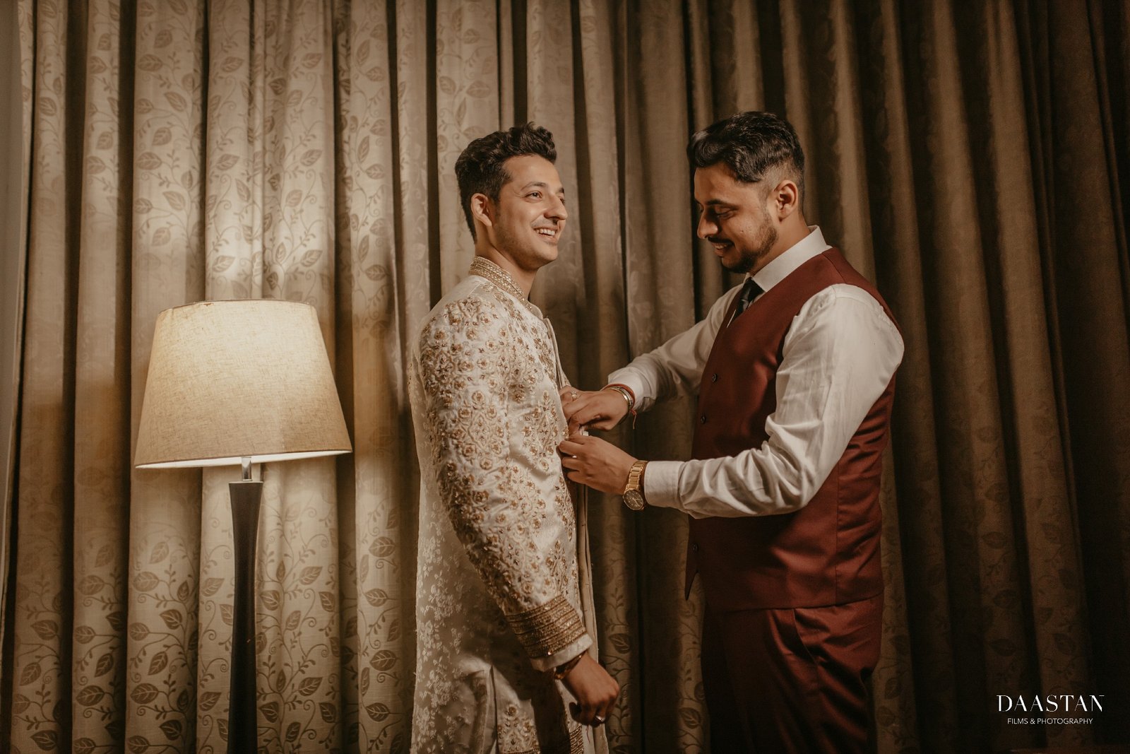 Groom candidly photographed getting ready in hotel, cinematic wedding production India