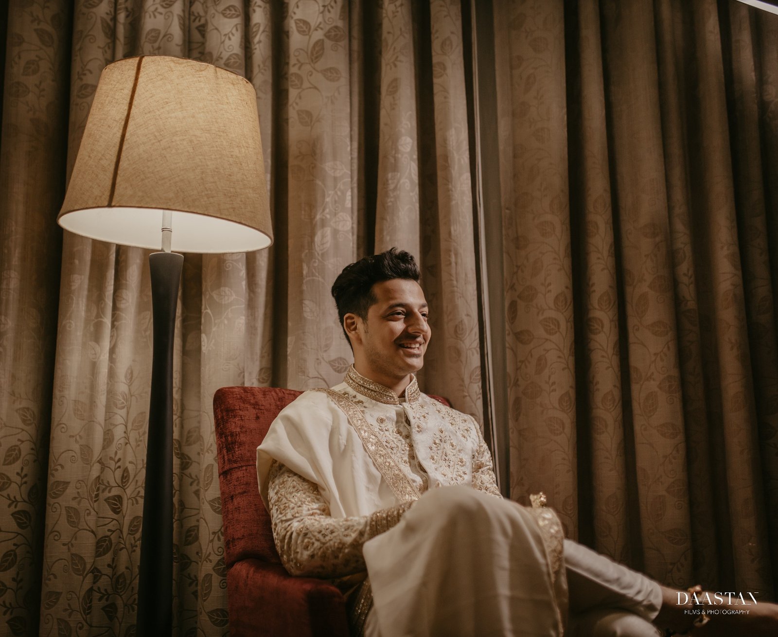 Candid groom portrait in hotel suite, pre-wedding getting-ready shoot by Indian wedding production house