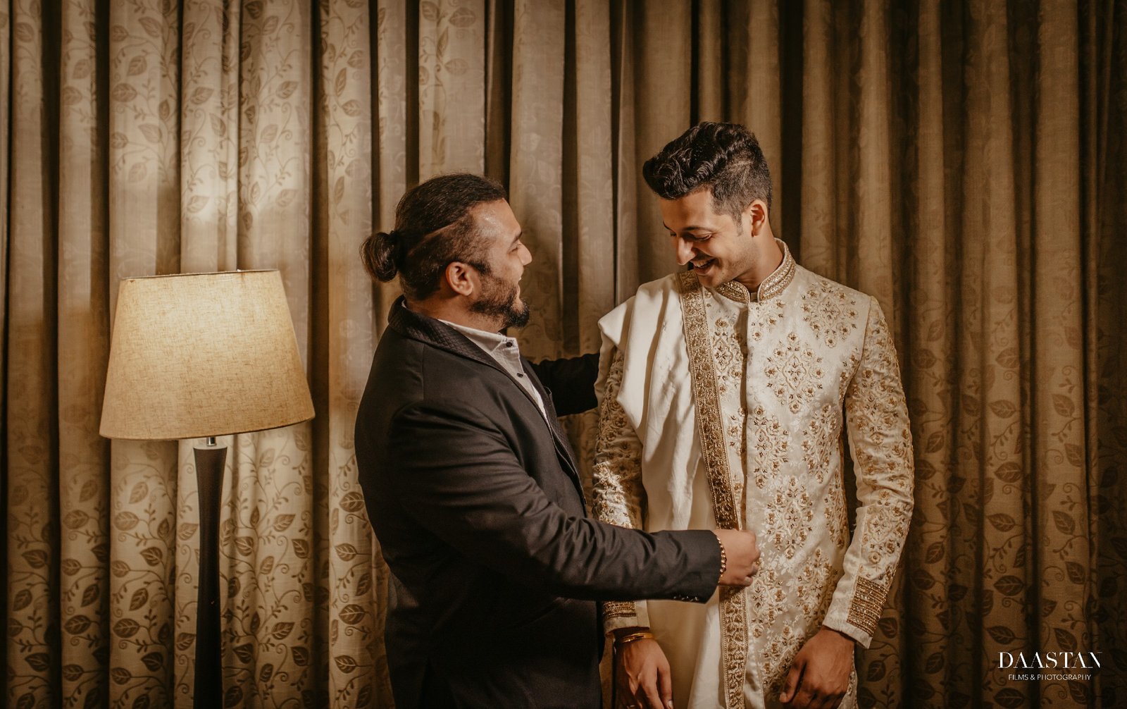 Dapper groom in ivory sherwani captured candidly by Indian wedding production house