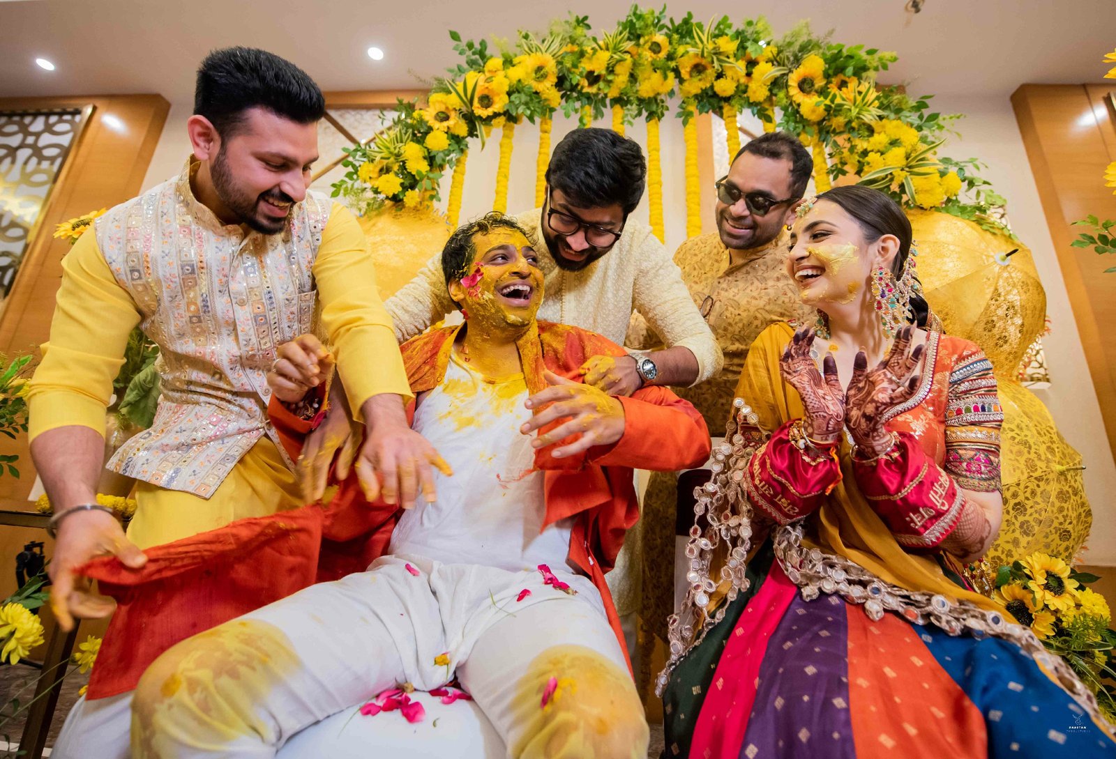 Couple laughing during haldi turmeric ritual, candid Indian wedding ceremony photography