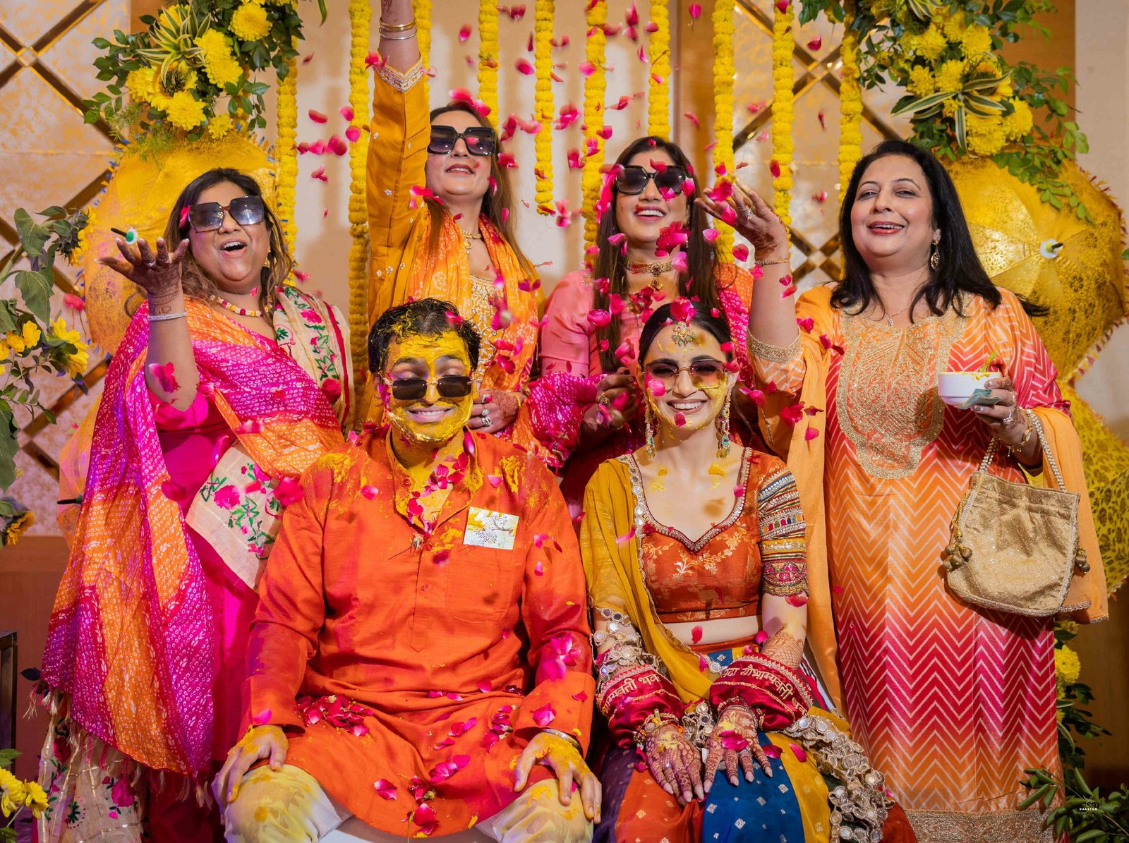Cheerful family celebration during haldi ceremony at Indian wedding, candid photography by production house