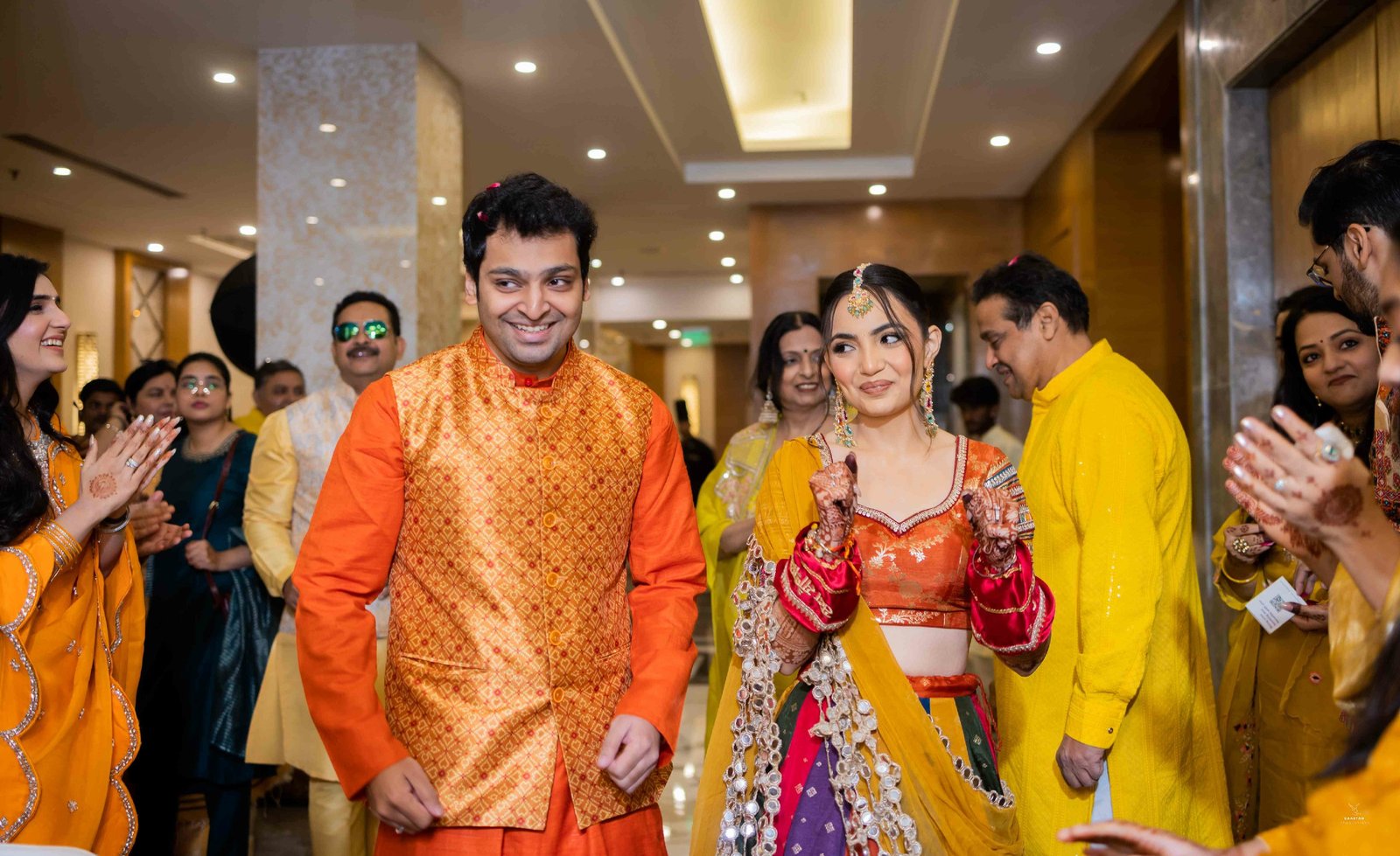 Guests celebrating and applying haldi at Indian wedding ceremony, candid event photography