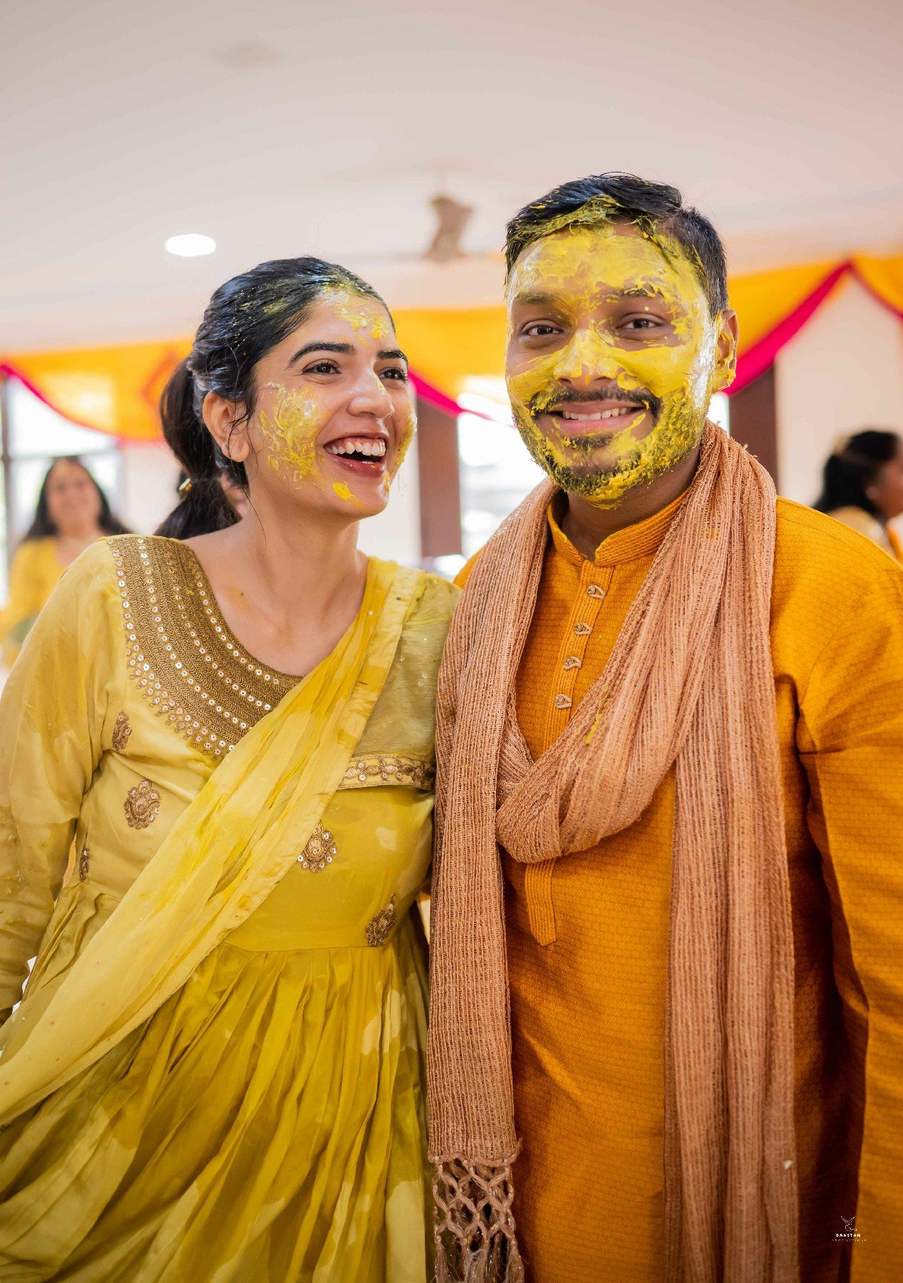 Couple laughing joyfully during haldi ceremony, candid Indian wedding production house photography