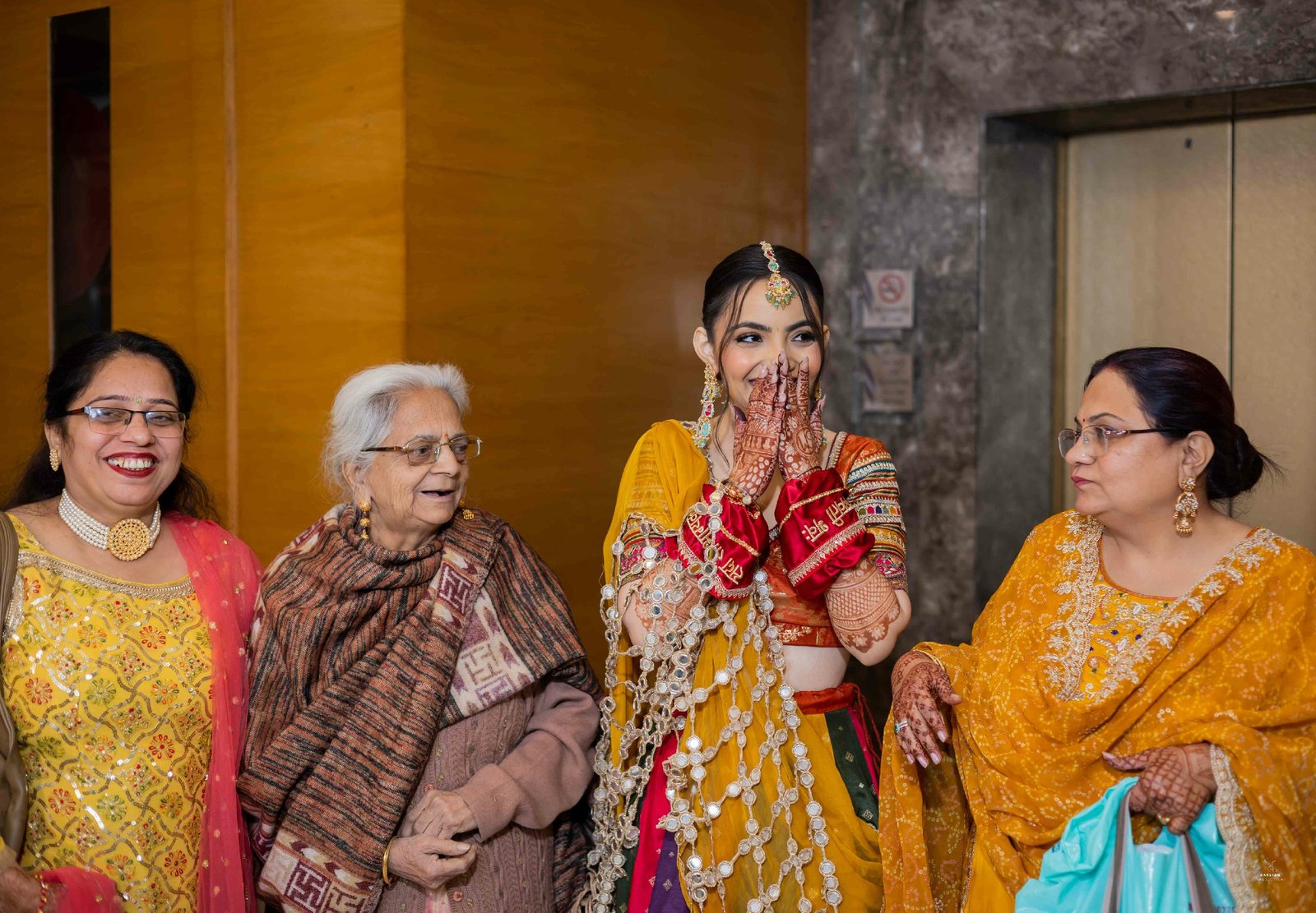 Touching moment of grandparents blessing couple at haldi ceremony, candid Indian wedding photography