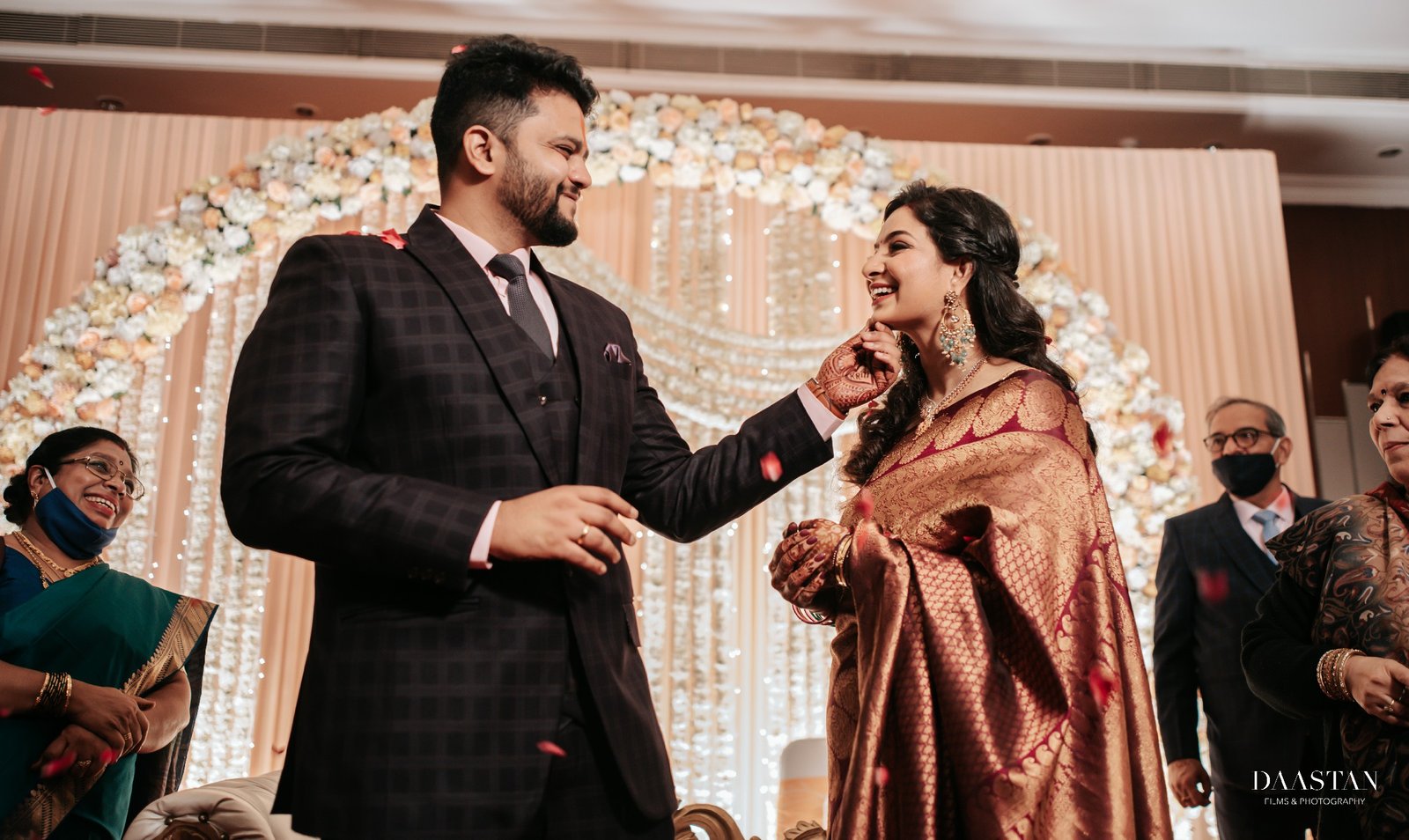 Jaimala garland exchange ceremony between bride and groom, cinematic wedding photography India