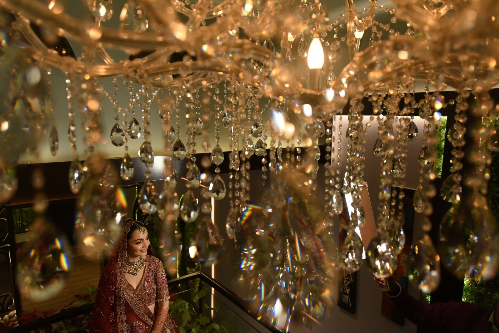 Opulent wedding reception decor with crystal chandeliers and ambient lighting, Indian wedding production house