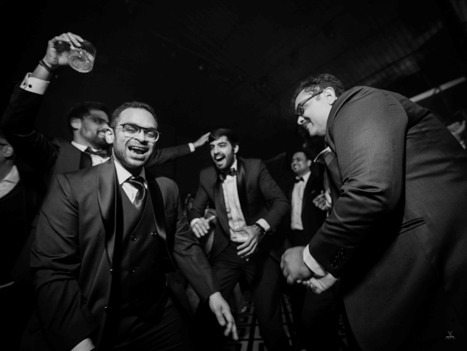 Black and white candid photography of guests dancing at Indian wedding reception