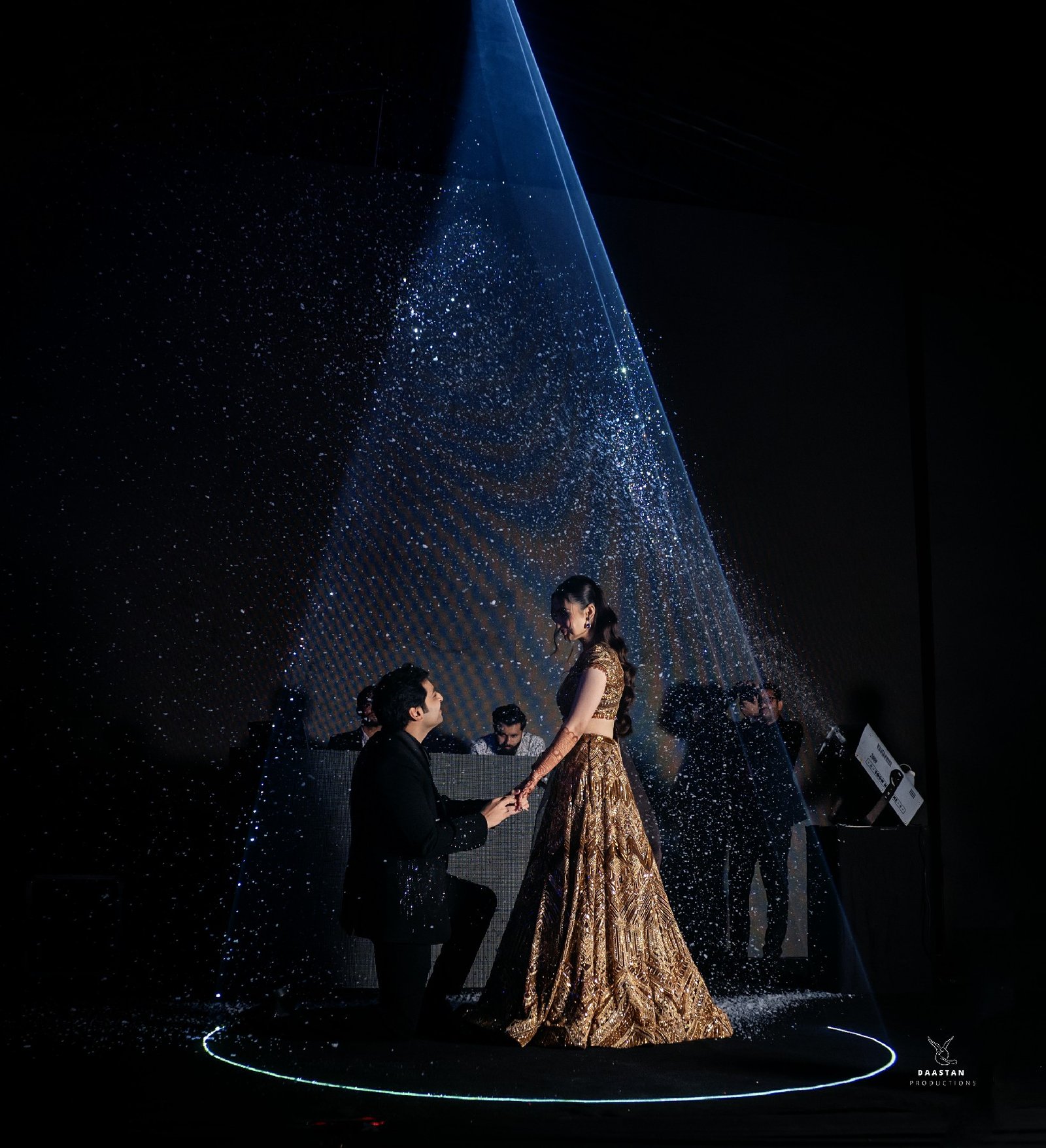 Dramatic spotlight on performer during sangeet night, professional wedding event photography India